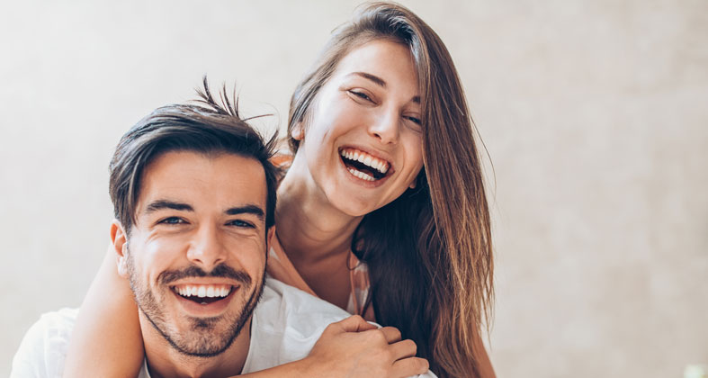 Couple laughing with cosmetic smiles
