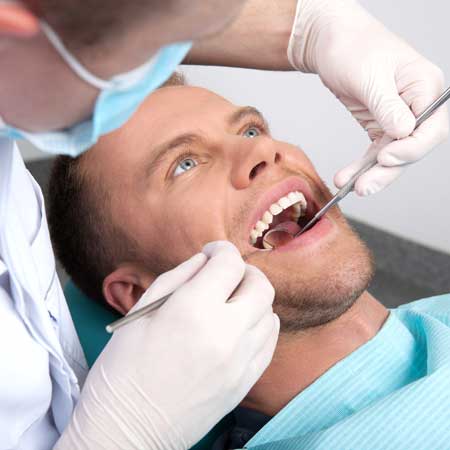 Man Getting Ready for Dental Extraction and Exam in Dentist Chair